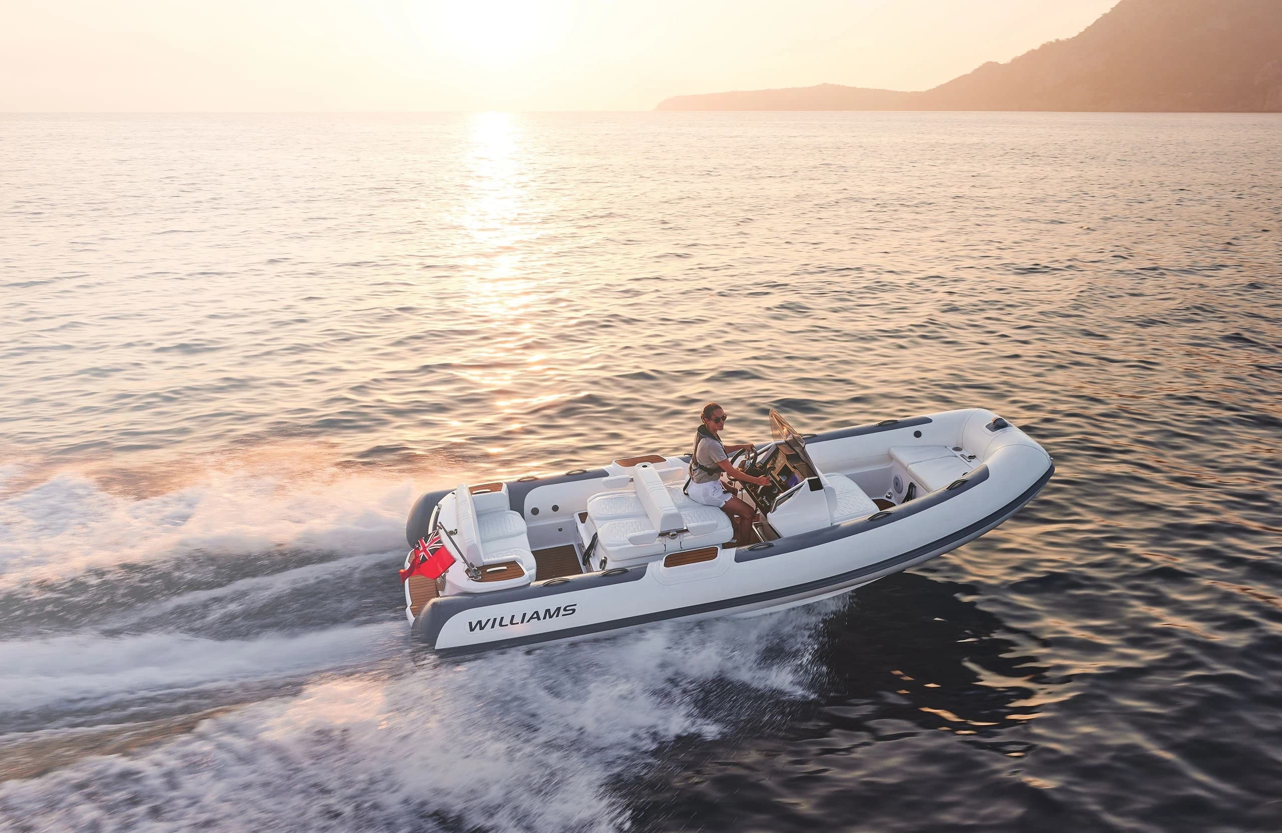Williams DieselJet 565 product banner, three-quarter bow view underway